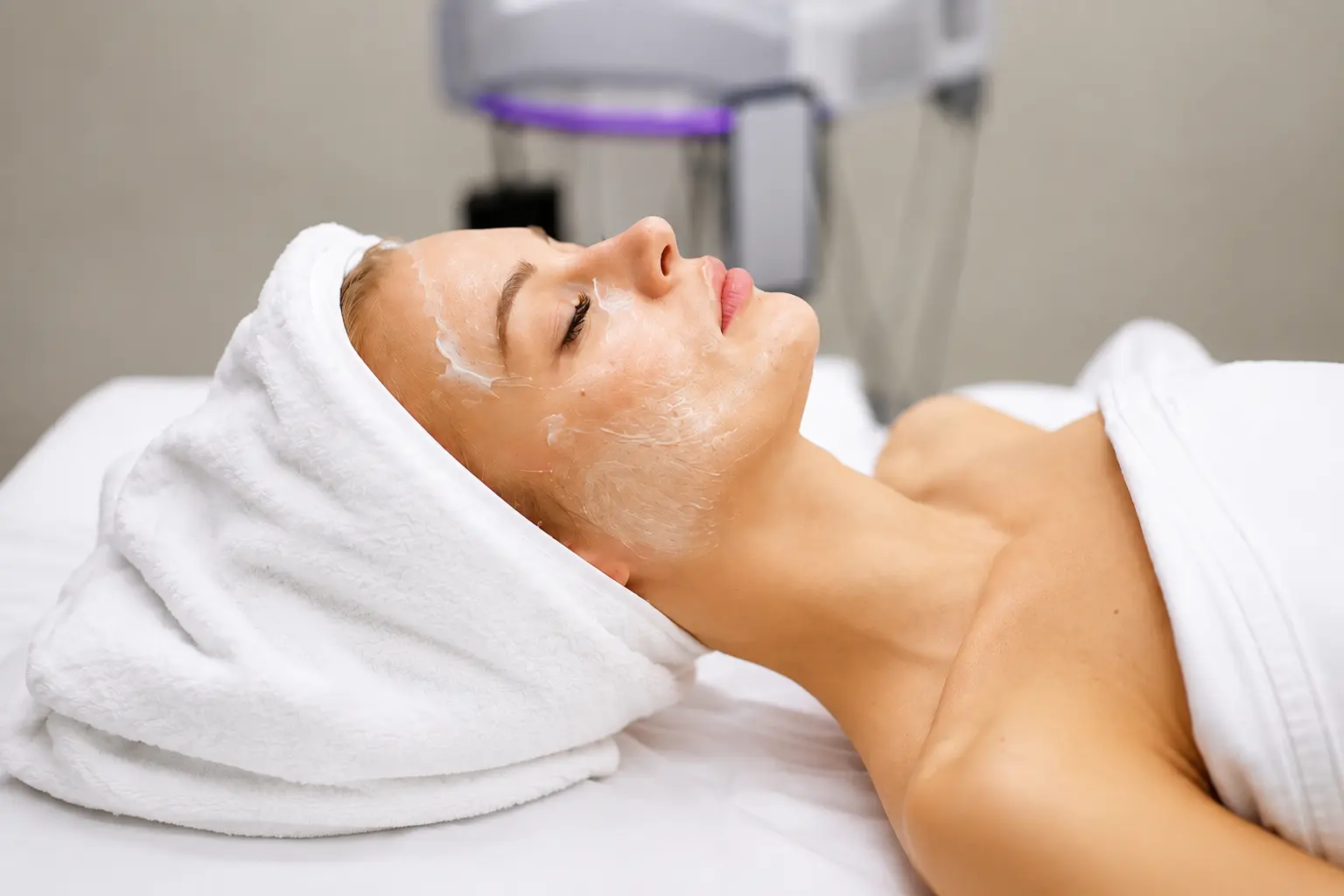 Woman receiving a professional facial treatment at a beauty clinic in Forest Hills